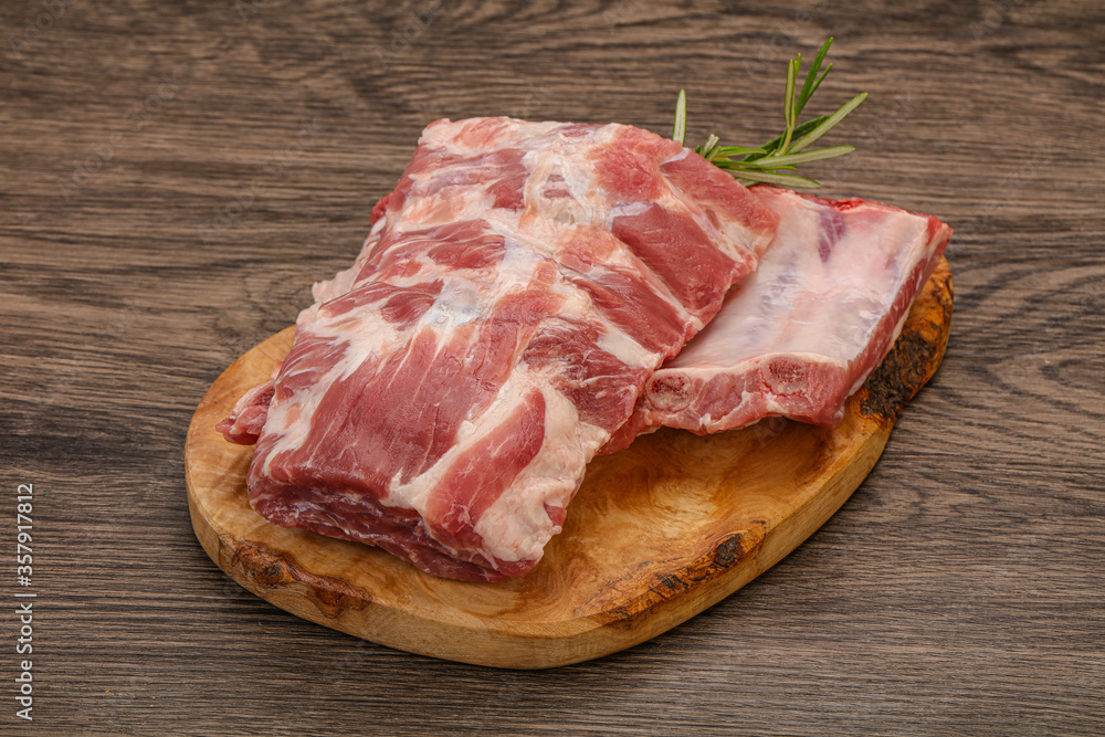 Raw pork ribs served rosemary