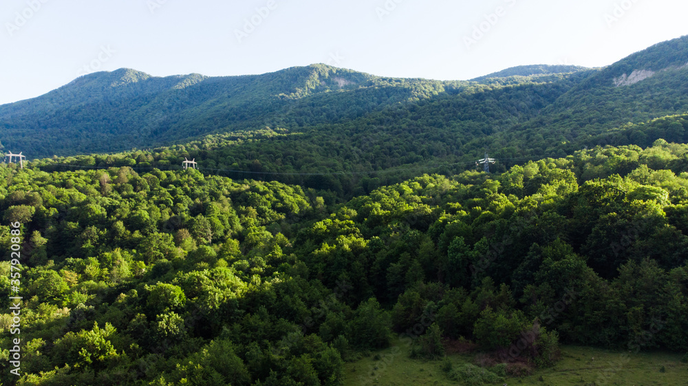 Beautiful landscape view of the valley. Trees, river and mountain range in the background. Clear sky, Sunny spring day. Drone shot
A bird's-eye view of the landscape. drone photography