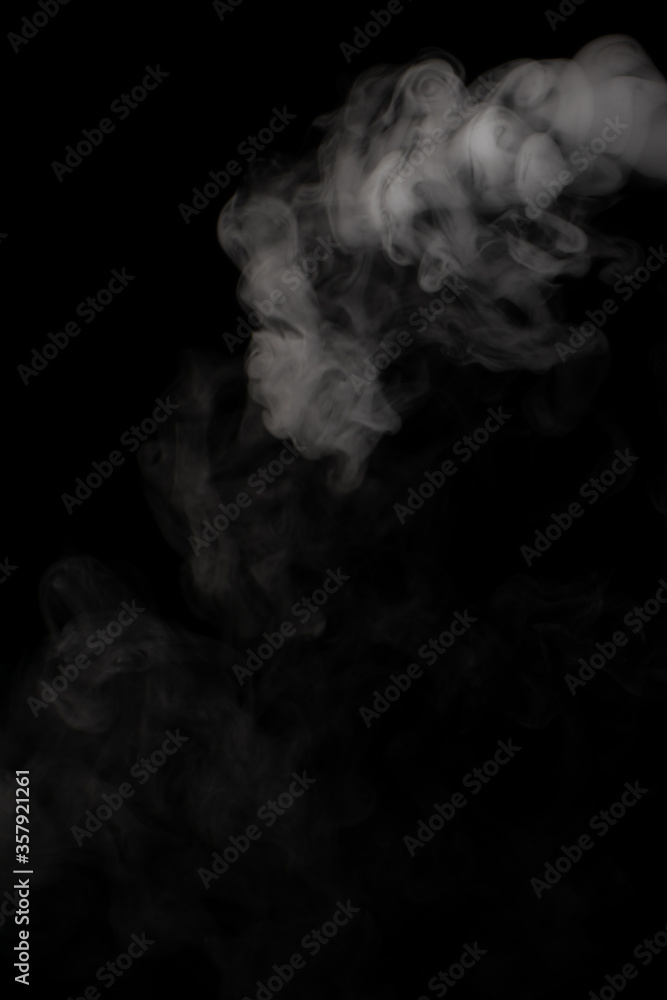A stream of white smoke on a black background mixes randomly creating bizarre swirl patterns A stream of white smoke on a black background mixes randomly creating bizarre swirl patterns