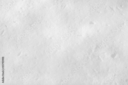 White snow on the ground on a clear sunny day. Snow texture