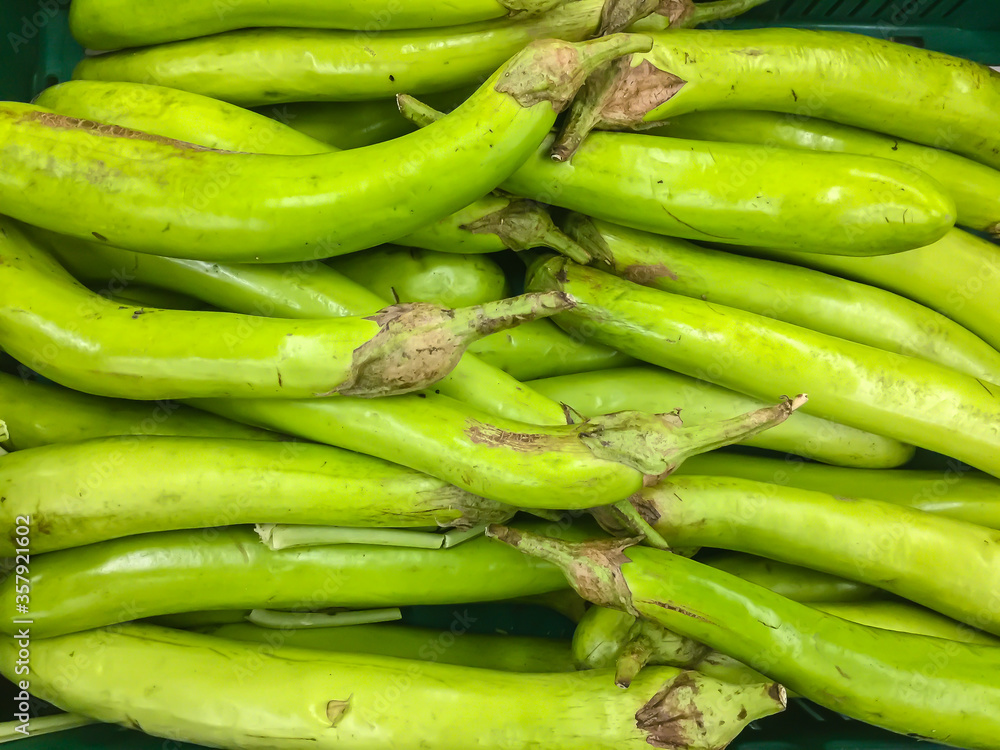 Pile of Green long eggplant for sale in stall at the supermarket. Long Green Eggplant is an important recipe ingredient in authentic Thai foods