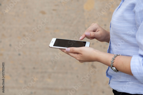 woman hand smart phone in street