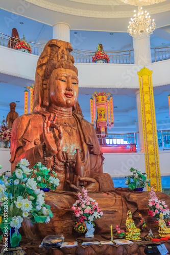 Beautiful wood statue of Guan Yin at Huay Pla Kang Temple, Chiang Rai, Thailand. Guan Yin is a female Bodhisattva in Thai Buddhism, which means someone that reached enlightenment. photo