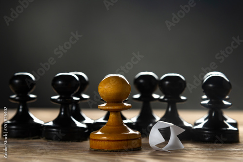 White pawn with a discarded paper crown. Black lives matter
