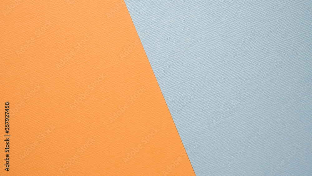 Textural background in trendy pastels: grey and orange in a minimalistic concept. Flat bed, top view. High quality photo