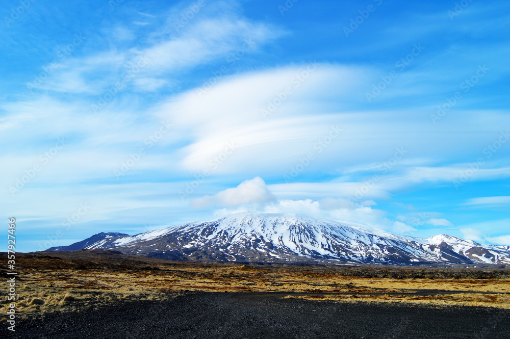 Snowy mountains, volcanic land, meadow and amazing clouds