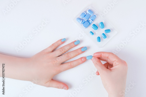 Wallpaper Mural Manicure on woman hand with false nails on a white background. Torontodigital.ca