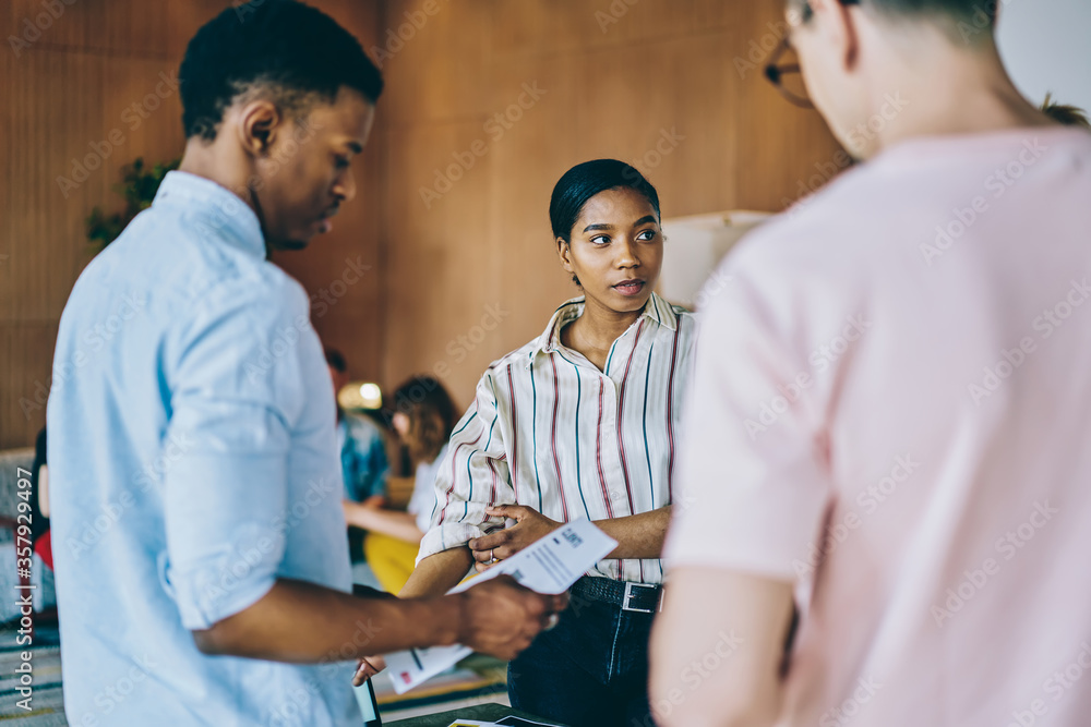 Obraz premium Pleased diverse business partners brainstorming in office