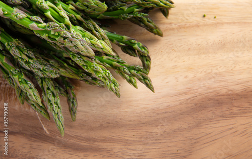  Bunches Fresh green asparagus on burlap and on a board. top view - image. High quality photo