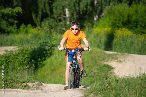 Teen cyclist riding on hilly terrain