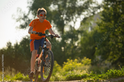 Cycling, boy cyclist in sunglasses, close up. Copyspace