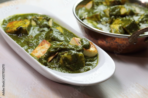 A bowl of Palak Paneer made of Paneer cheese dipped in mildly spiced Spinach gravy.