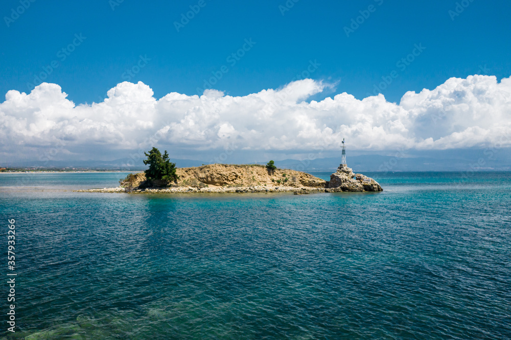 Scenic view to lighthouse at small island at Halkidiki, Greece Scenic view to lighthouse at small island at Halkidiki, Greece