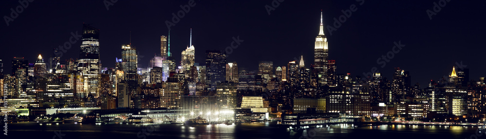 Panoramic night view of Manhattan skyline from Jersey City. New York. USA.