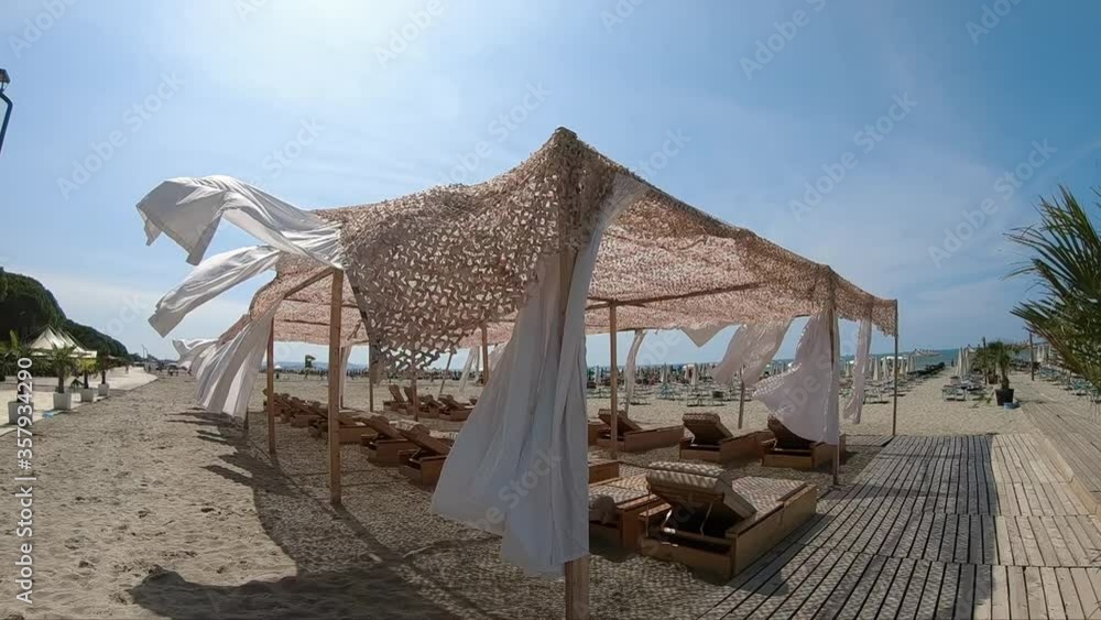 Suumer vacation luxury resort white tent on a sandy beach against the background of blue sunny sky Suumer vacation luxury resort white tent on a sandy beach against the background of blue sunny sky