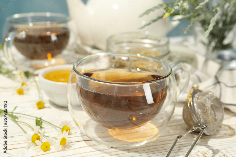 Composition with chamomile tea on white wooden table Composition with chamomile tea on white wooden table