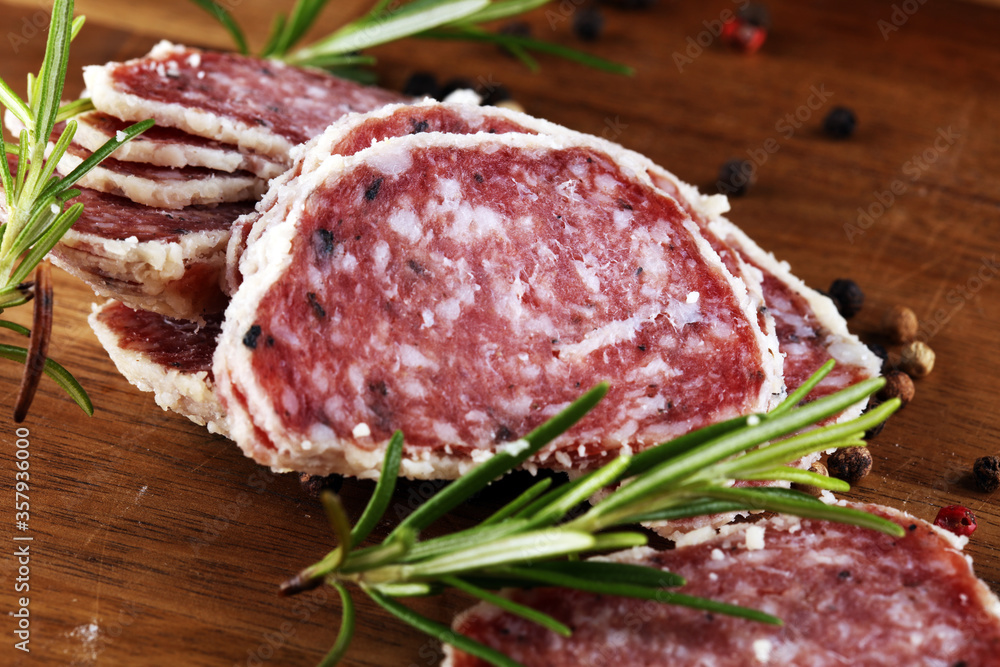 Salami truffle. The saltufo is a piece of salami mixed with summer truffle and parmesan on table Salami truffle. The saltufo is a piece of salami mixed with summer truffle and parmesan on table