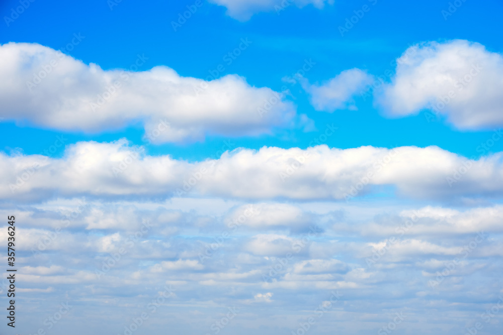 Obraz premium Large white clouds on a blue sky background