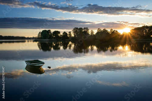 Fototapeta Naklejka Na Ścianę i Meble -  Rowing boat floating over the Elckie Lake waters. Masuria, Poland.