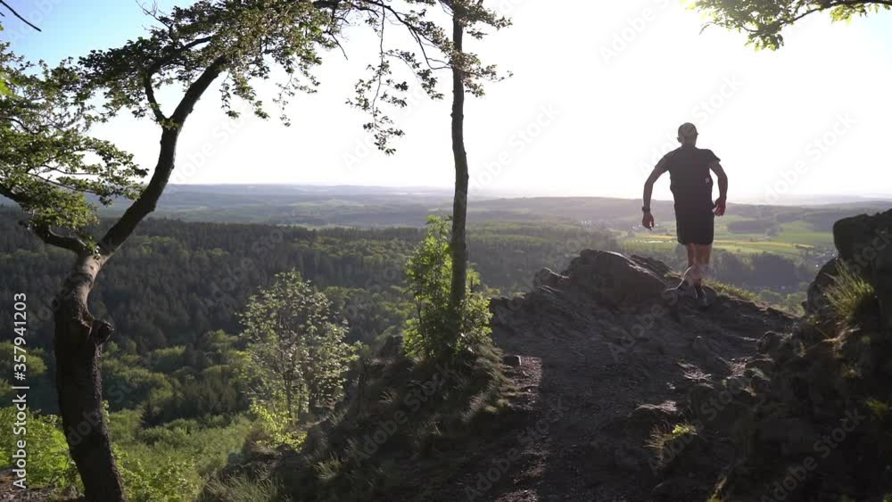 The trail runner runs to the edge of the mountain. The runner stops after running. Running in nature The trail runner runs to the edge of the mountain. The runner stops after running. Running in nature
