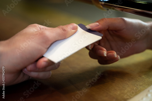Receptionist of a hotel front desk giving a key from the room to a customer