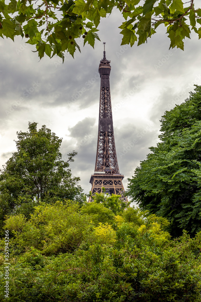 Paris, France - June 10, 2020: Green trees with Eiffel Tower in background in Paris