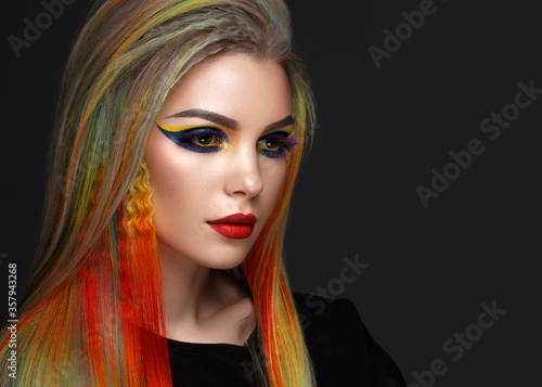 Beautiful girl with multi-colored hair and creative make-up and hairstyle. Beauty face.