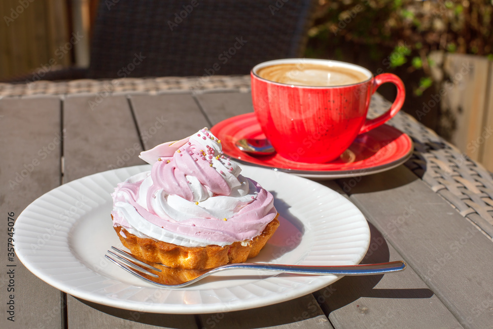 Coffee and cake on the table of an outdoor cafe Coffee and cake on the table of an outdoor cafe