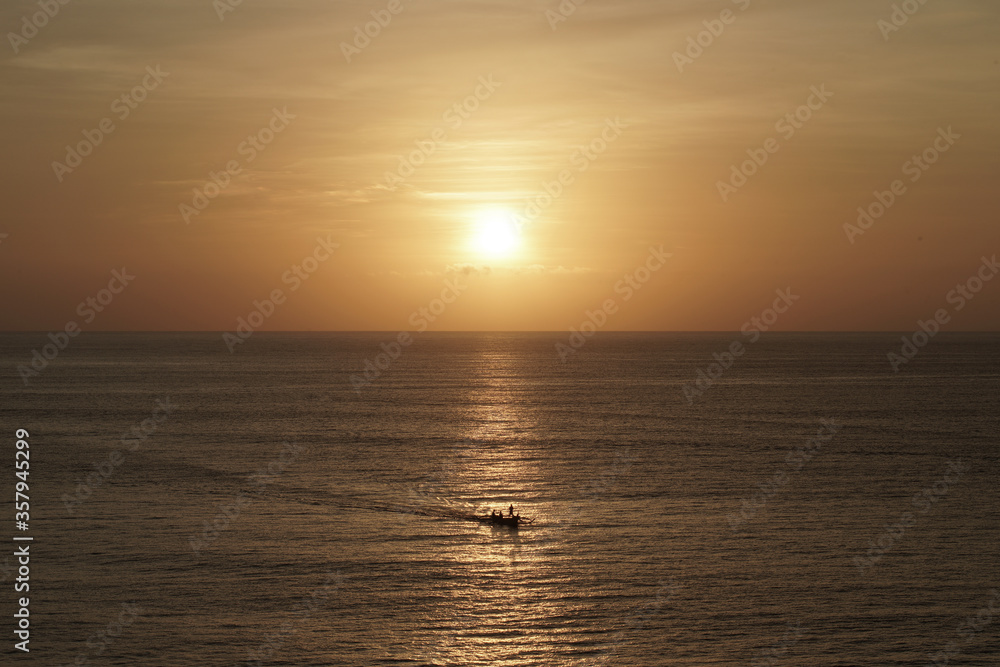 Sunset on the sea with small boat