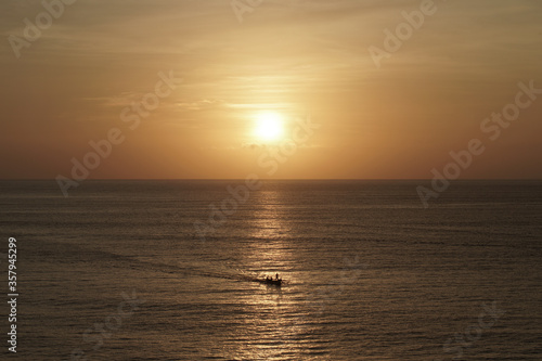 Sunset on the sea with small boat