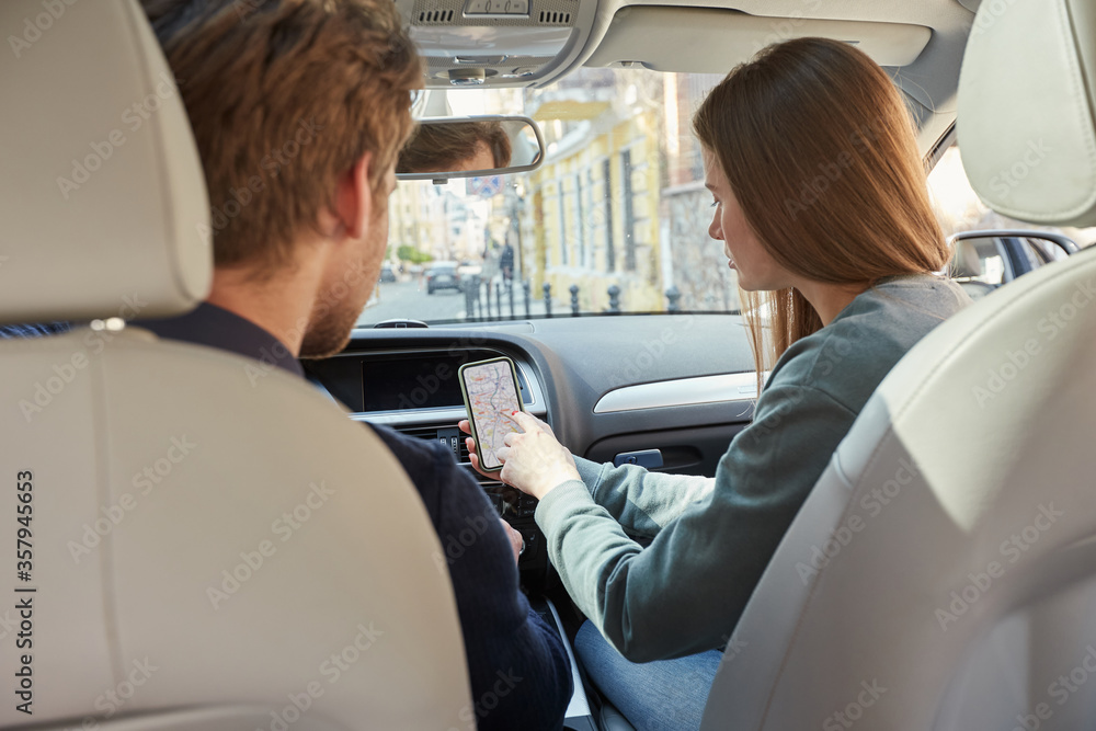 Attentive couple using navigation map in car Attentive couple using navigation map in car