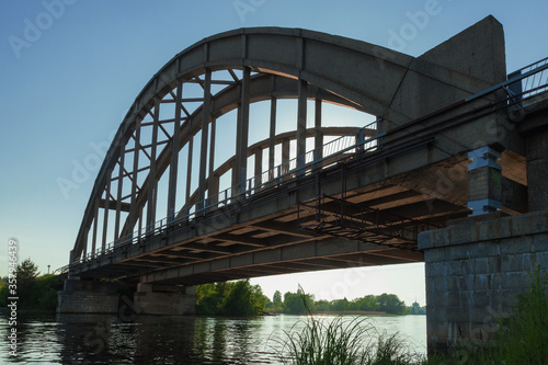 Old reinforced concrete bridge connects two banks of the river
