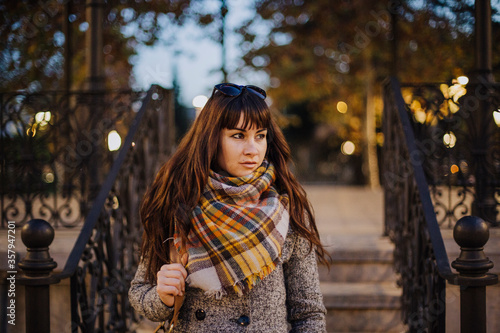 Girl walking through the city in autumn