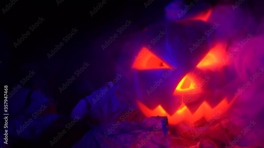 Halloween, pumpkins on the leaves. red luminous lights inside them, smoke from the side, smoke from a car. Halloween, pumpkins on the leaves. red luminous lights inside them, smoke from the side, smoke from a car.