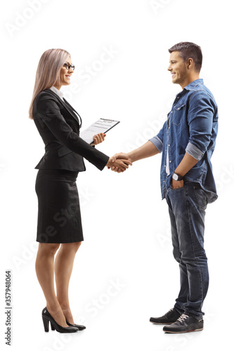Businesswoman shaking hands with a causal young man