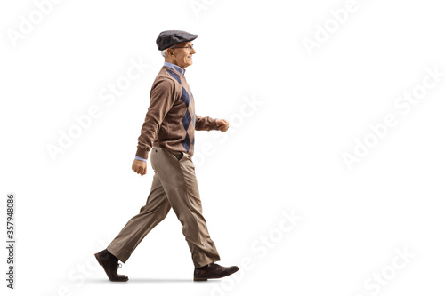 Full length profile shot of an elderly man walking fast