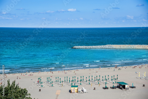 Aerial view of the beach in Constanta with blue black sea water in summer holiday in Romania © cristianbalate