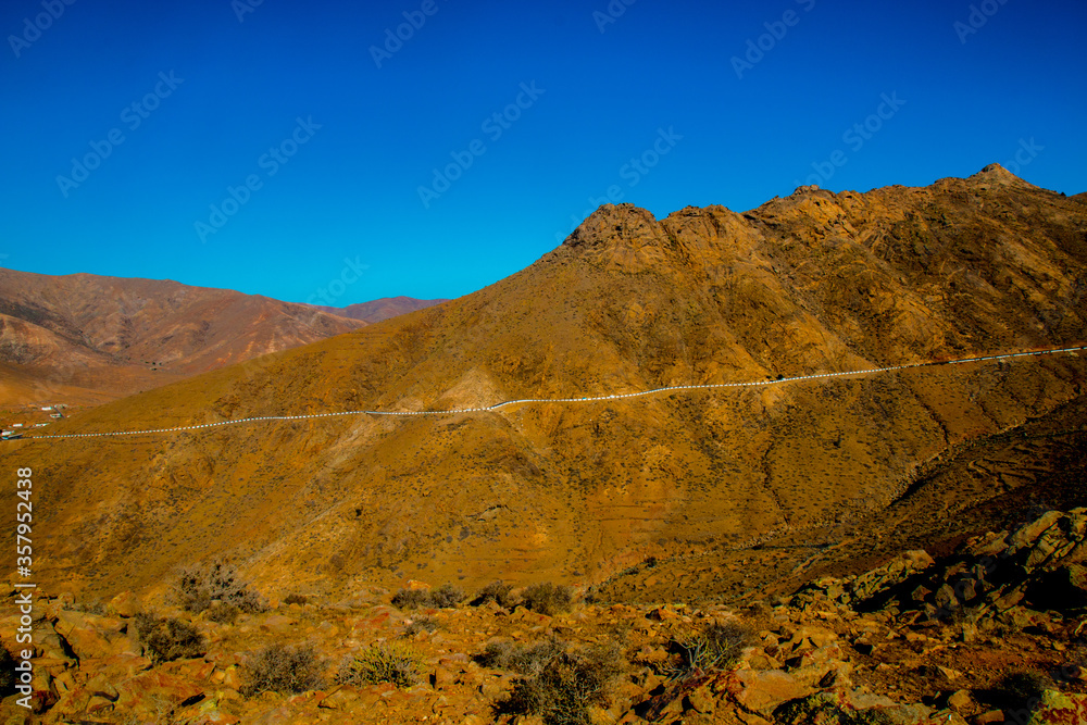 Fototapeta premium Landscape of Panoramic vulcanic mountains and Atlantic Ocean , dunes of coralejo and Gran Tarajal Port in Fuerteventura, Lanzarote