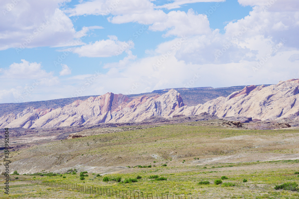 Mountain ridges and green grass at the edge of the San Rafael Swell in the southwest desert