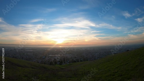 Sunset time-lapse East San Francisco Bay Area; green hills visible in the foreground; Hayward, California