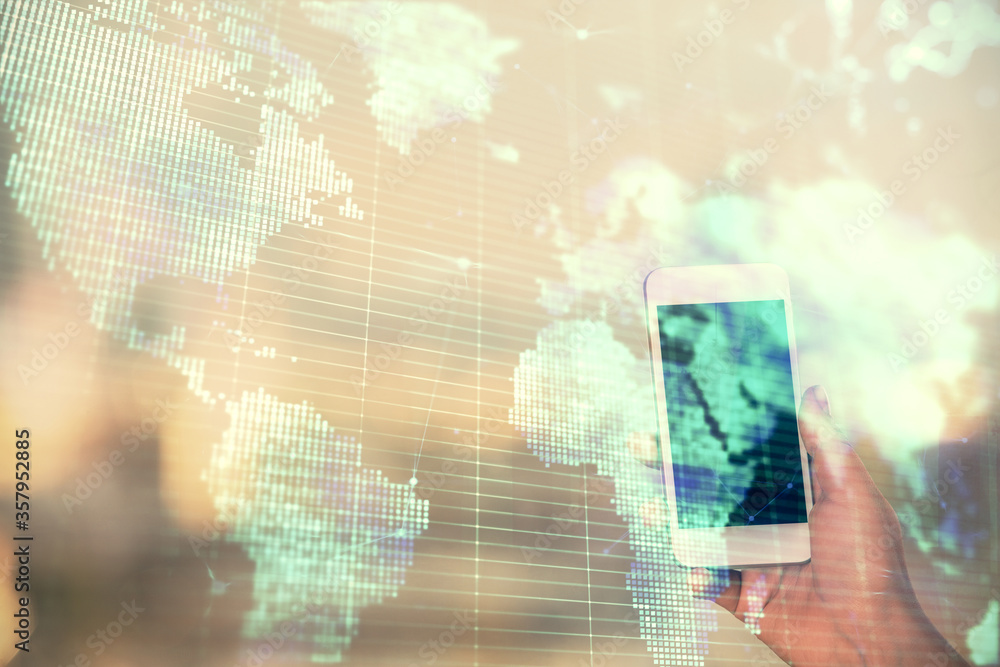 Obraz premium Double exposure of business theme sketch hologram and woman holding and using a mobile device.