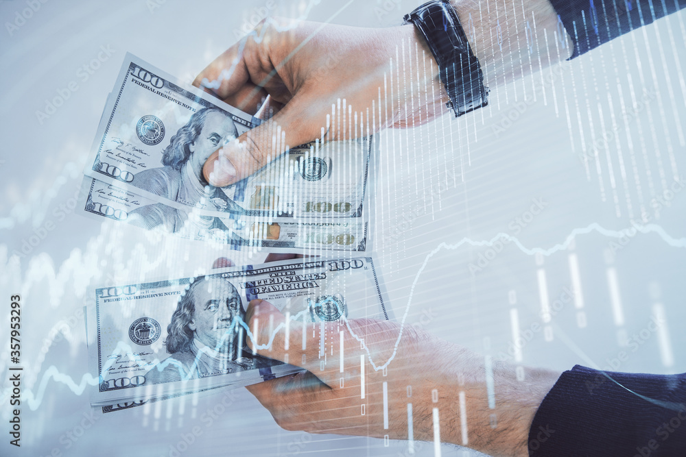 Multi exposure of financial graph drawing hologram and USA dollars bills and man hands. Analysis concept. Multi exposure of financial graph drawing hologram and USA dollars bills and man hands. Analysis concept.