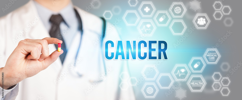 Close-up of a doctor giving you a pill with CANCER inscription, medical concept Close-up of a doctor giving you a pill with CANCER inscription, medical concept