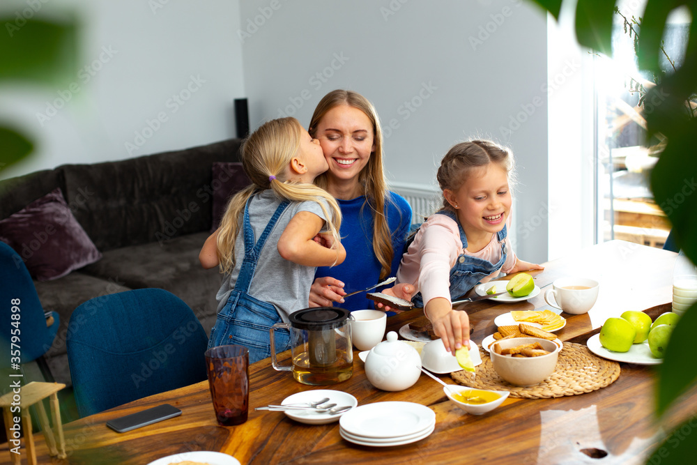 Loving mother enjoying breakfast with adorable kids Loving mother enjoying breakfast with adorable kids