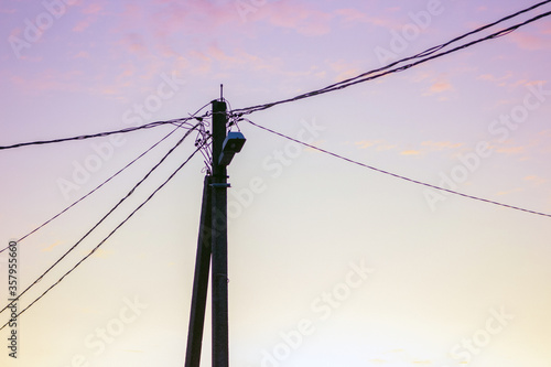 Power lines and wires on the background of sunset