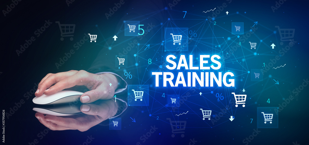 hand holding wireless peripheral with SALES TRAINING inscription, online shopping concept hand holding wireless peripheral with SALES TRAINING inscription, online shopping concept