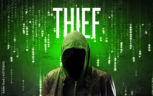 Faceless hacker with THIEF inscription, hacking concept