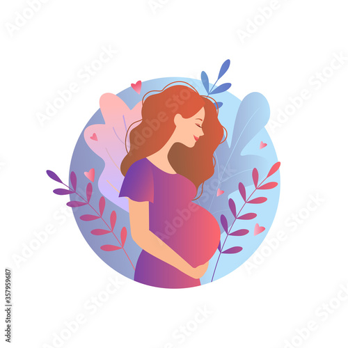 beautiful pregnant woman with hand on her stomach on a background of foliage. young woman stroking belly. Pregnancy.
