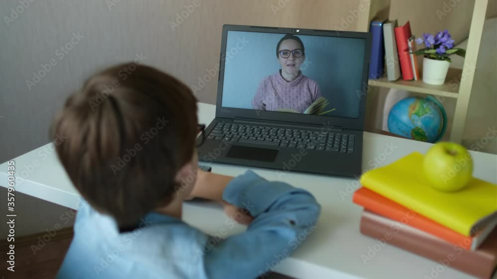 Distance education online lesson concept. Child Little Boy Kid schoolboy using tablet laptop computer for school homework, studying at home. Coronavirus COVID-19 quarantine. 4 K Distance education online lesson concept. Child Little Boy Kid schoolboy using tablet laptop computer for school homework, studying at home. Coronavirus COVID-19 quarantine. 4 K
