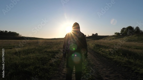 Free young man is training in summer in park at dawn. healthy guy is engaged in fitness, jogging in country. Jogger man breathes fresh air. sporty and healthy lifestyle